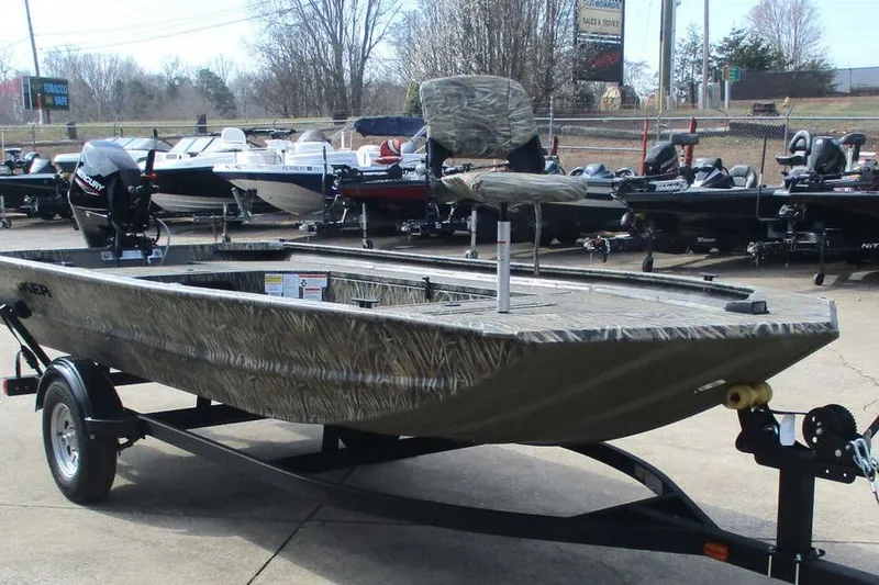 Slide: The Image of 2026 Tracker Grizzly 1654 T Sportsman boat on trailer in outdoor showroom. - 4