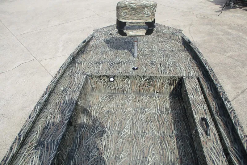 Slide: The Image of 2026 Tracker Grizzly 1654 T Sportsman boat with camouflage design and seating. - 6
