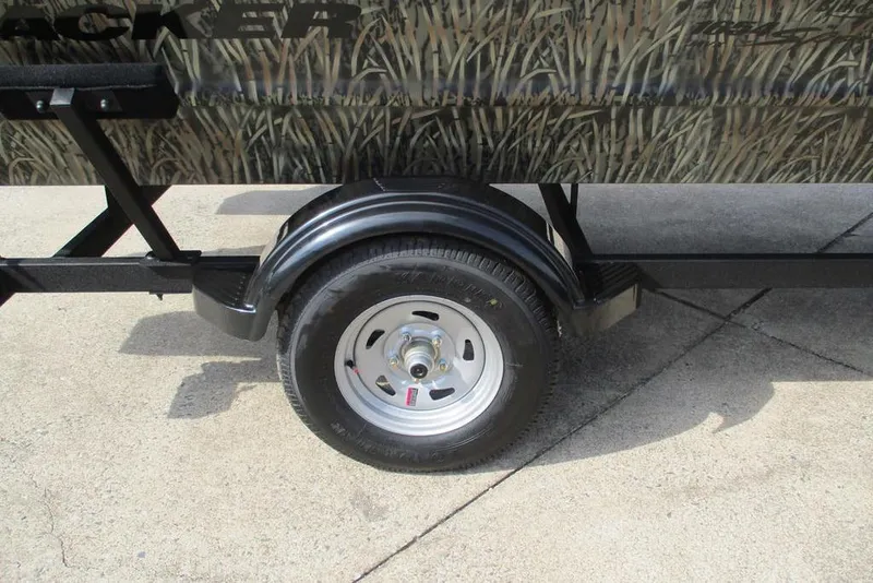 Slide: The Image of 2026 Tracker Grizzly 1654 T Sportsman trailer wheel with camouflage design. - 7