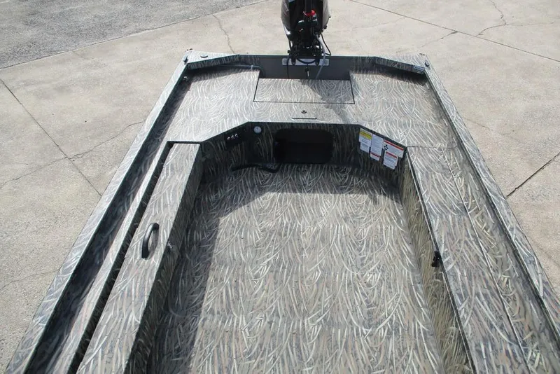 Slide: The Image of 2026 Tracker Grizzly 1654 T Sportsman boat interior with camo pattern and motor. - 8