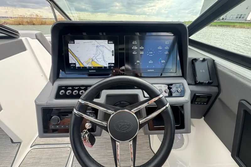 Slide: The Image of 2023 Cobalt R4 boat dashboard with Garmin navigation screens and steering wheel. - 18