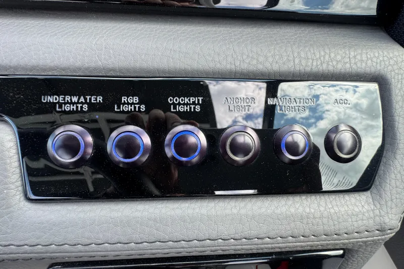 Slide: The Image of Control panel of a 2023 Cobalt R4 boat with various light switches. - 22