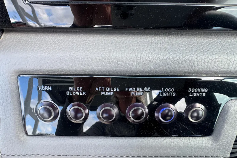 Slide: The Image of Control panel of a 2023 Cobalt R4 boat with various switches. - 23