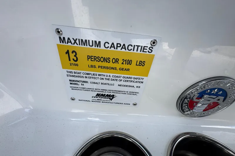 Slide: The Image of 2023 Cobalt R4 boat capacity label, 13 persons or 2100 lbs, U.S. Coast Guard compliant. - 25