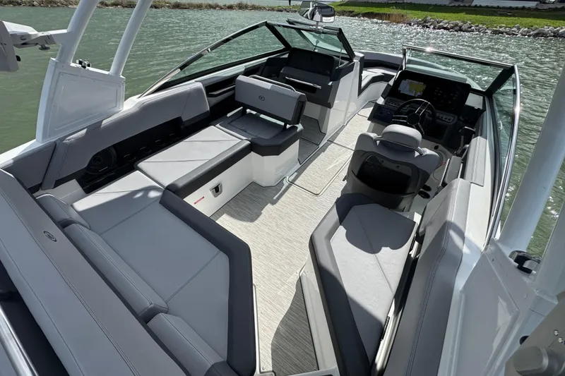 Slide: The Image of 2023 Cobalt R4 boat interior with sleek seating and modern dashboard on a sunny day. - 28