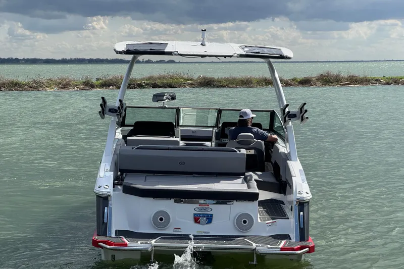 Slide: The Image of 2023 Cobalt R4 boat cruising on a lake under cloudy skies. - 3