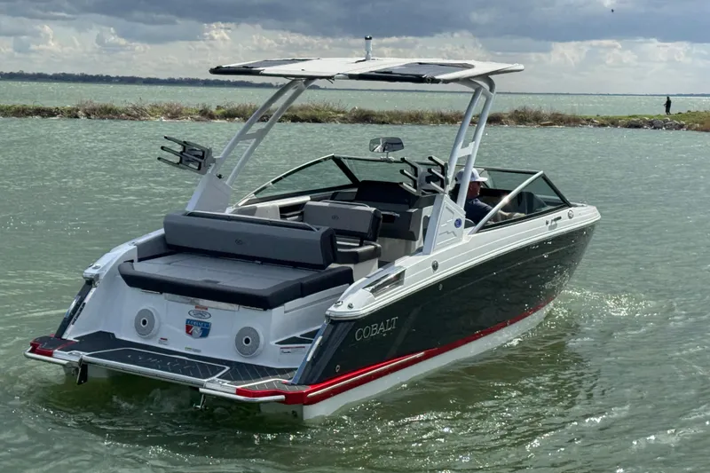 Slide: The Image of 2023 Cobalt R4 boat cruising on a lake under a cloudy sky. - 4