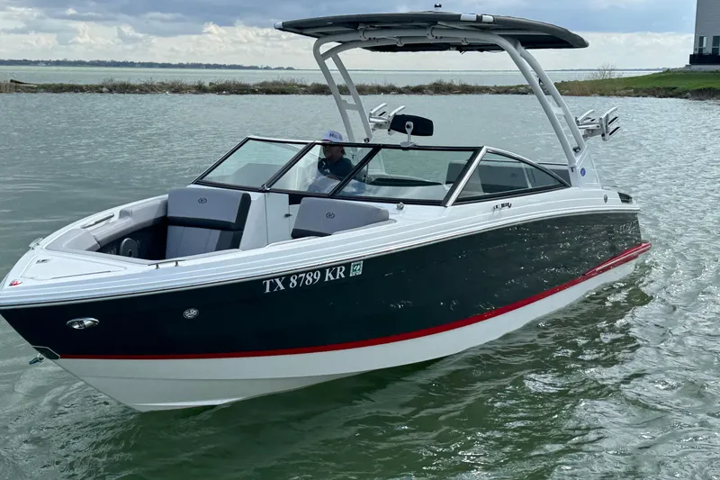 Slide: The Image of 2023 Cobalt R4 boat cruising on a lake with a sleek design and modern features. - 8