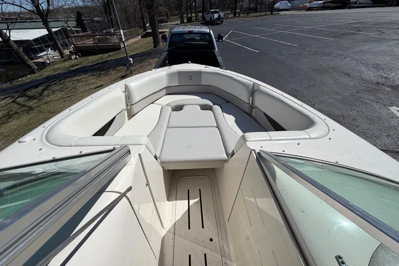 Slide: The Image of 2008 Bryant 268 boat with spacious seating, parked in a lot. - 10