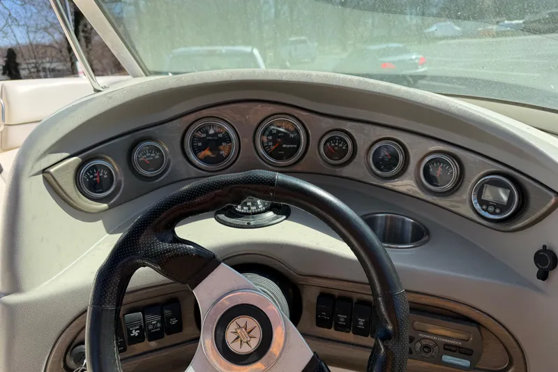 Slide: The Image of Dashboard of a 2008 Bryant 268 boat with gauges and steering wheel. - 17