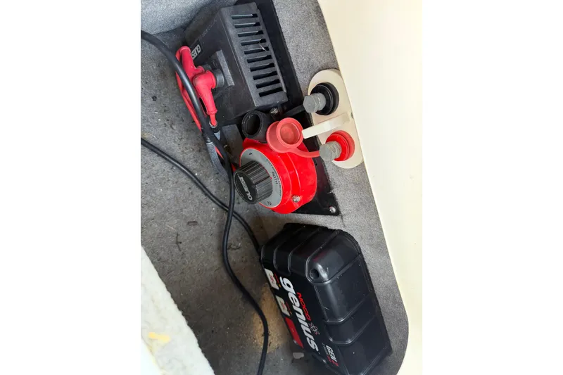 Slide: The Image of Battery compartment of a 2008 Bryant 268 boat with charger and cables. - 18