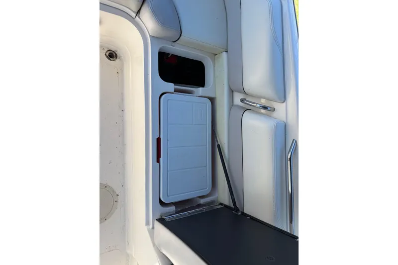 Slide: The Image of 2008 Bryant 268 boat interior storage compartment with white cushioned seating. - 19