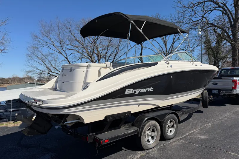 Slide: The Image of 2008 Bryant 268 boat on trailer, black and white design, parked outdoors. - 3