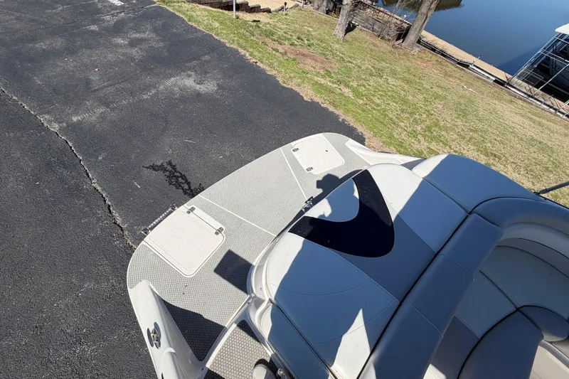 Slide: The Image of Rear view of a 2008 Bryant 268 boat on a paved surface near a lake. - 8