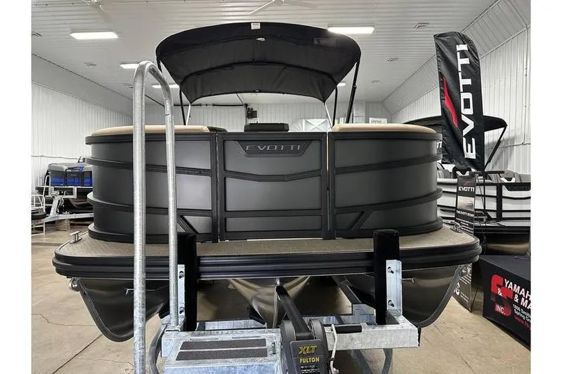 Slide: The Image of 2026 Evotti 521QL pontoon boat displayed indoors on a trailer. - 15