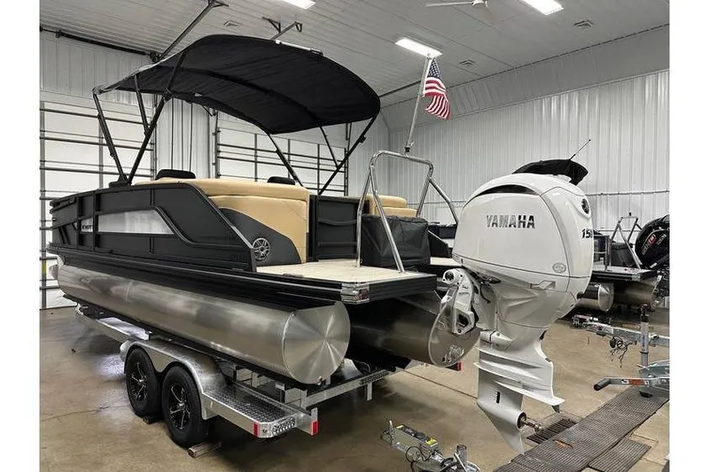 Slide: The Image of 2026 Evotti 521QL pontoon boat with Yamaha outboard motor in a garage setting. - 19
