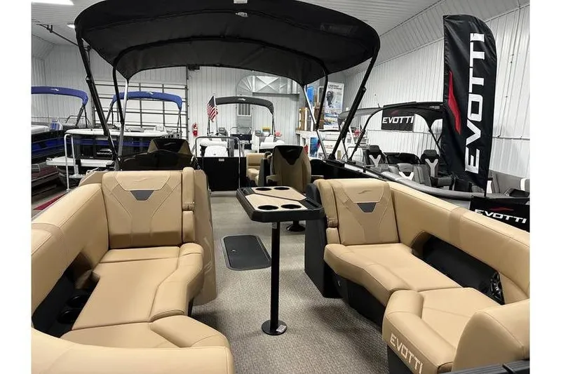 Slide: The Image of Luxurious 2026 Evotti 521QL pontoon boat interior with tan seating and canopy. - 21