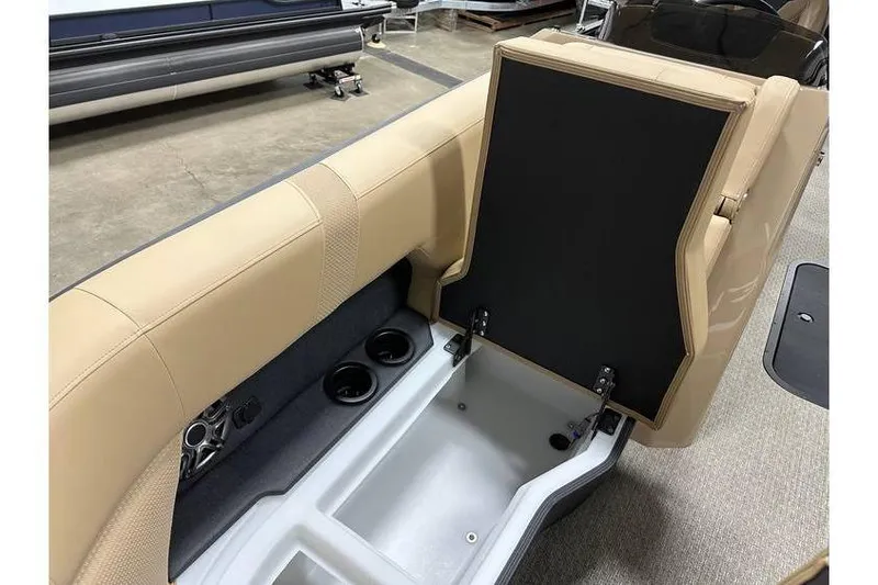 Slide: The Image of Evotti 521QL 2026 boat interior with beige seating and storage compartment. - 23