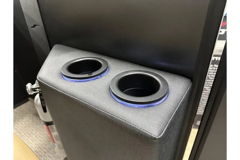 Slide: The Image of Cup holders with blue LED lights in a 2026 Evotti 521QL vehicle interior. - 31