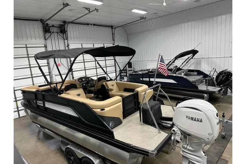 Slide: The Image of 2026 Evotti 521QL pontoon boat in a garage, featuring Yamaha outboard motor. - 43