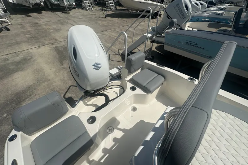 Slide: The Image of 2026 Pioneer 180 Sportfish boat with Suzuki outboard engine, featuring gray seating and spacious deck. - 11