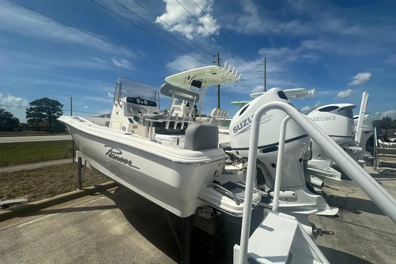Slide: The Image of 2026 Pioneer 180 Sportfish boat with Suzuki outboard motor under a clear blue sky. - 3