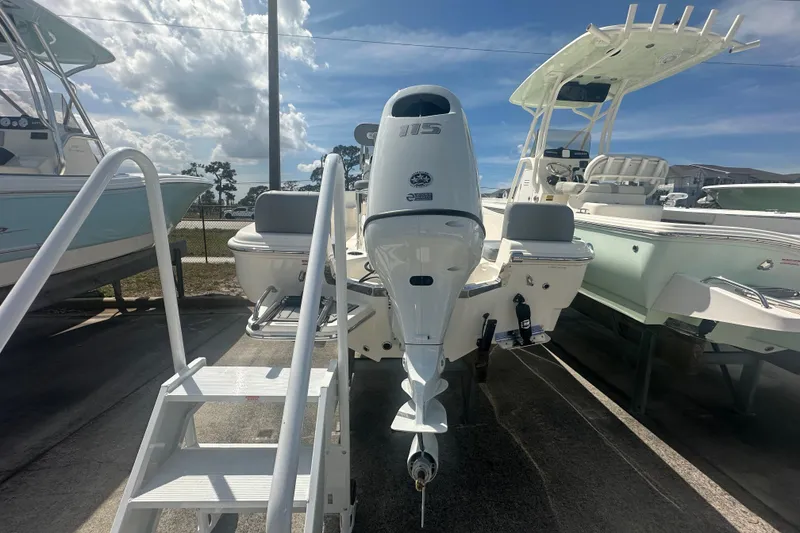 Slide: The Image of 2026 Pioneer 180 Sportfish boat with outboard motor, displayed outdoors under a clear sky. - 4