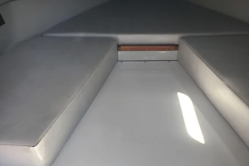 Slide: The Image of Interior cabin of a 1989 Boston Whaler Challenger boat with cushioned seating. - 17