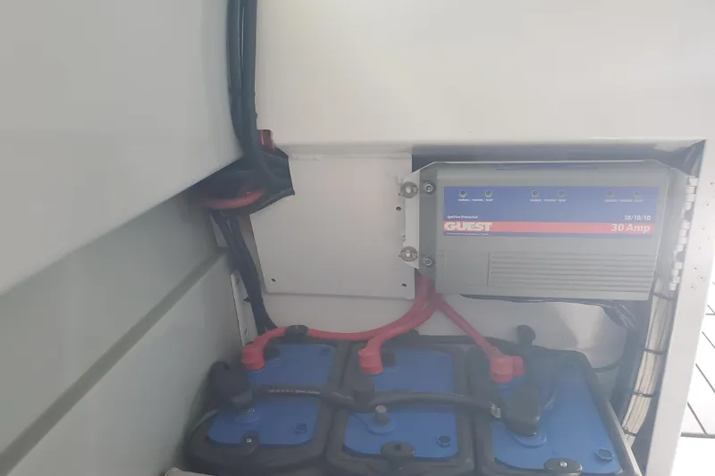 Slide: The Image of 1989 Boston Whaler Challenger battery compartment with Guest 30 Amp charger. - 18