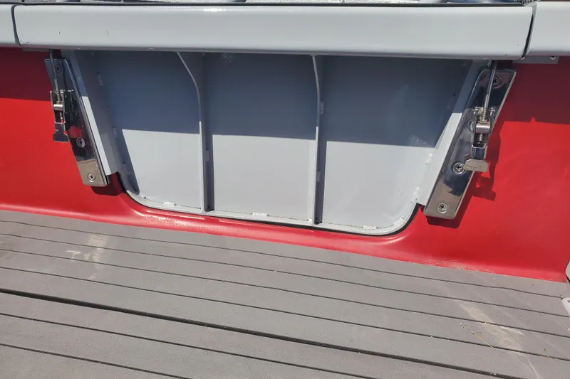 Slide: The Image of 1989 Boston Whaler Challenger boat deck with red and gray detailing. - 22