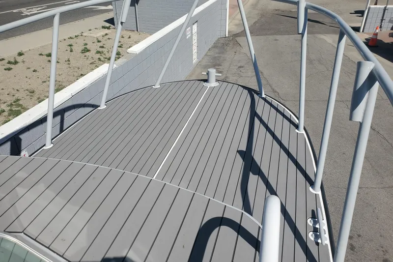 Slide: The Image of 1989 Boston Whaler Challenger boat deck with gray flooring and railings. - 26