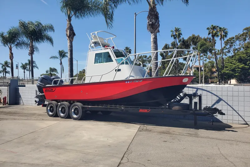 Slide: The Image of 1989 Boston Whaler Challenger boat on trailer, parked near palm trees. - 3