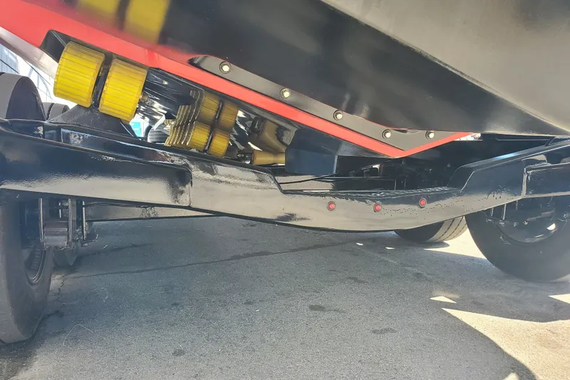 Slide: The Image of 1989 Boston Whaler Challenger boat trailer with yellow rollers and black frame. - 31