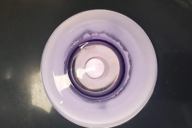 Slide: The Image of Close-up of a purple glass bowl with a circular design, viewed from above. - 33
