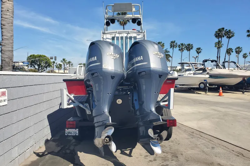 Slide: The Image of 1989 Boston Whaler Challenger with twin Yamaha 250 engines at a marina. - 6