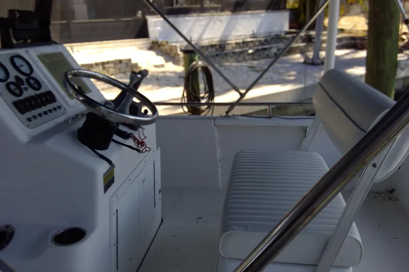 Slide: The Image of 2007 Tidewater 216 CC Adventure boat interior with steering console and seating. - 10