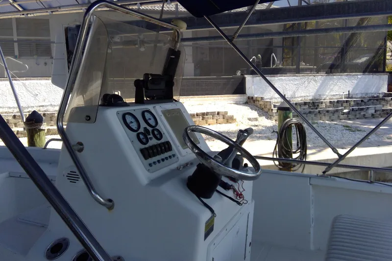 Slide: The Image of 2007 Tidewater 216 CC Adventure boat dashboard with steering wheel and gauges. - 11