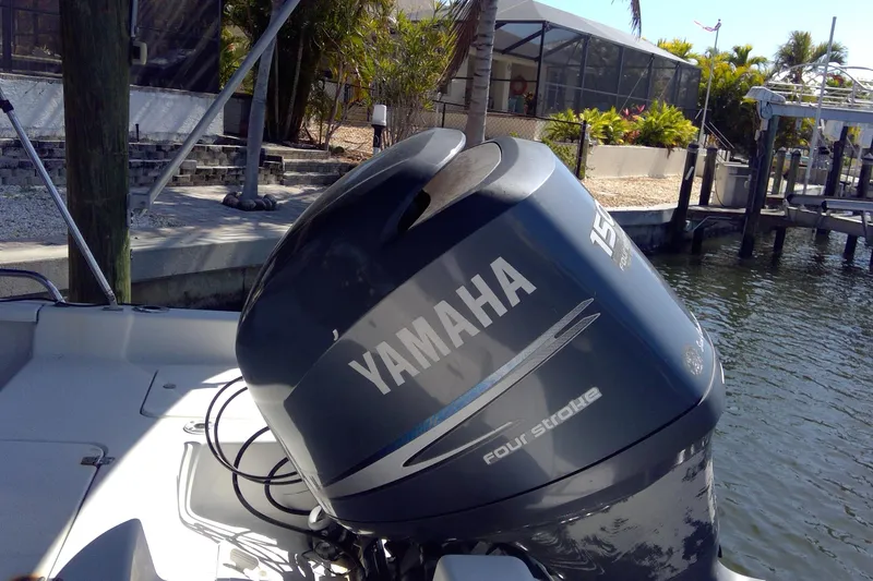 Slide: The Image of Outboard motor on 2007 Tidewater 216 CC Adventure boat, docked near waterfront. - 12
