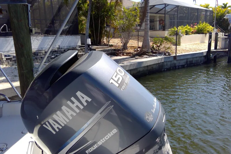 Slide: The Image of Tidewater 216 CC Adventure 2007 with Yamaha 150 four-stroke engine by a dock. - 13