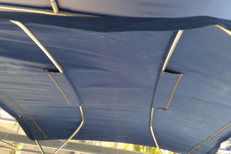 Slide: The Image of Blue canopy of a 2007 Tidewater 216 CC Adventure boat. - 14