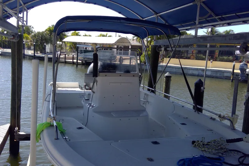 Slide: The Image of 2007 Tidewater 216 CC Adventure boat docked under a blue canopy. - 15