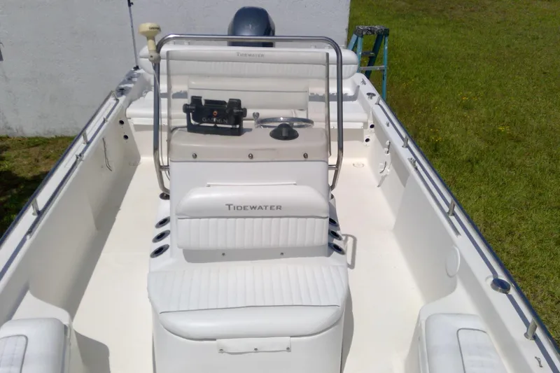 Slide: The Image of 2007 Tidewater 216 CC Adventure boat interior with white seating and steering console. - 20