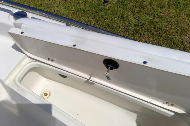 Slide: The Image of Open storage compartment on a 2007 Tidewater 216 CC Adventure boat, with visible key lock. - 22