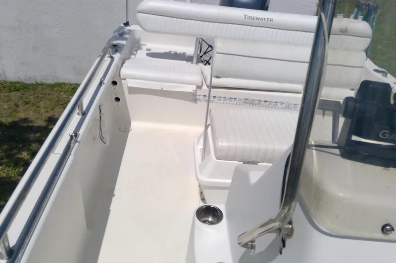 Slide: The Image of 2007 Tidewater 216 CC Adventure boat interior with white seating and console. - 24