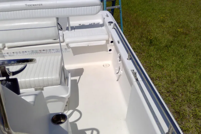 Slide: The Image of 2007 Tidewater 216 CC Adventure boat interior with white seating and clean deck. - 25