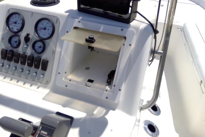 Slide: The Image of Control panel of a 2007 Tidewater 216 CC Adventure boat, featuring gauges and switches. - 28