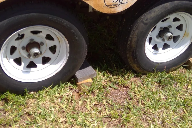 Slide: The Image of Trailer wheels of a 2007 Tidewater 216 CC Adventure boat on grass. - 33