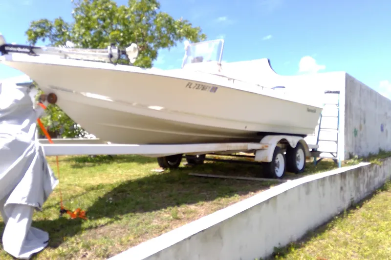 Slide: The Image of 2007 Tidewater 216 CC Adventure boat on trailer, parked outdoors on grass. - 34