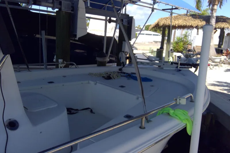 Slide: The Image of 2007 Tidewater 216 CC Adventure boat docked, featuring spacious deck and fishing equipment. - 4