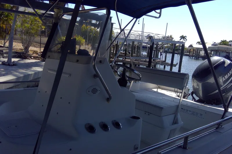 Slide: The Image of 2007 Tidewater 216 CC Adventure boat docked with Yamaha outboard motor. - 8
